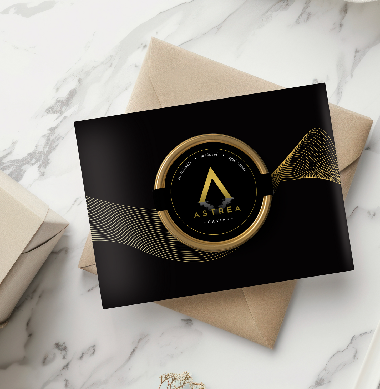 an Astrea Caviar greeting card is on top of a brown box sitting on a marble table