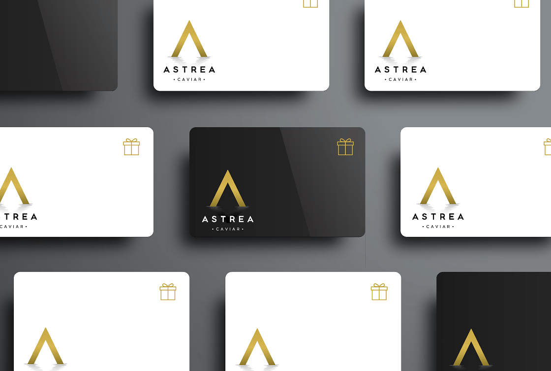 several Astrea Caviar gift cards are displayed on a table