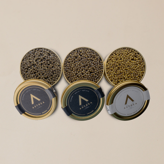 three cans of astrea caviar are opened and lined up in a row 