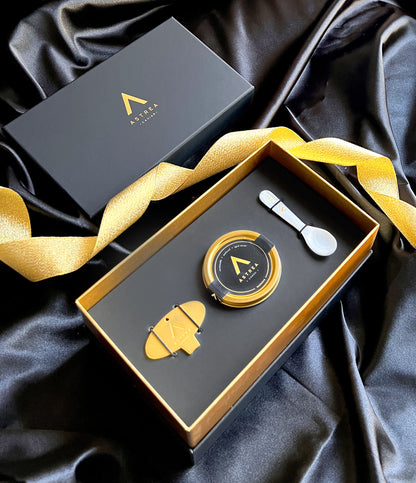 a black box with a jar of astrea caviar in it and a serving spoon