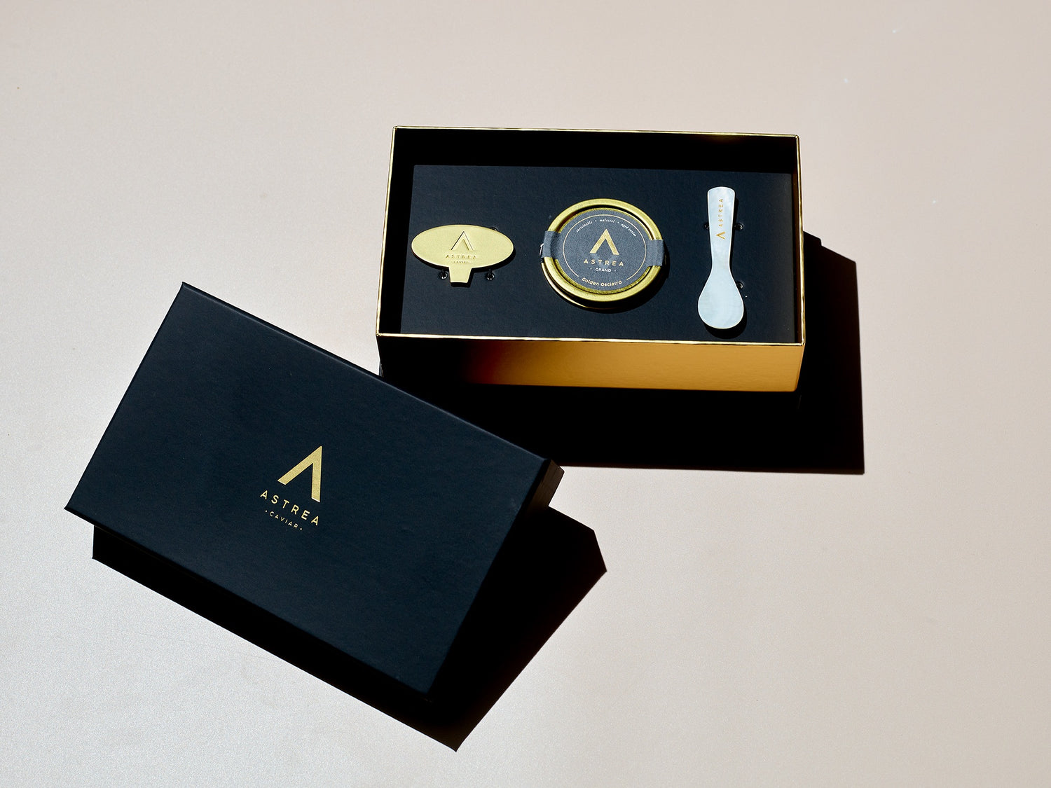  a black box holding caviar with the words Astrea Caviar on it 