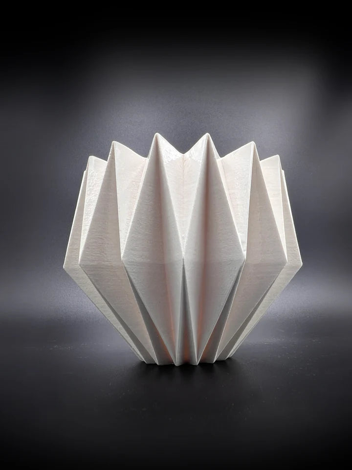 a white origami bowl on a black background