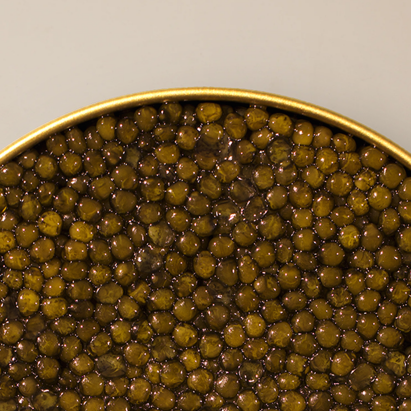 a close up of a bowl of caviar pearls with a gold outline and white background