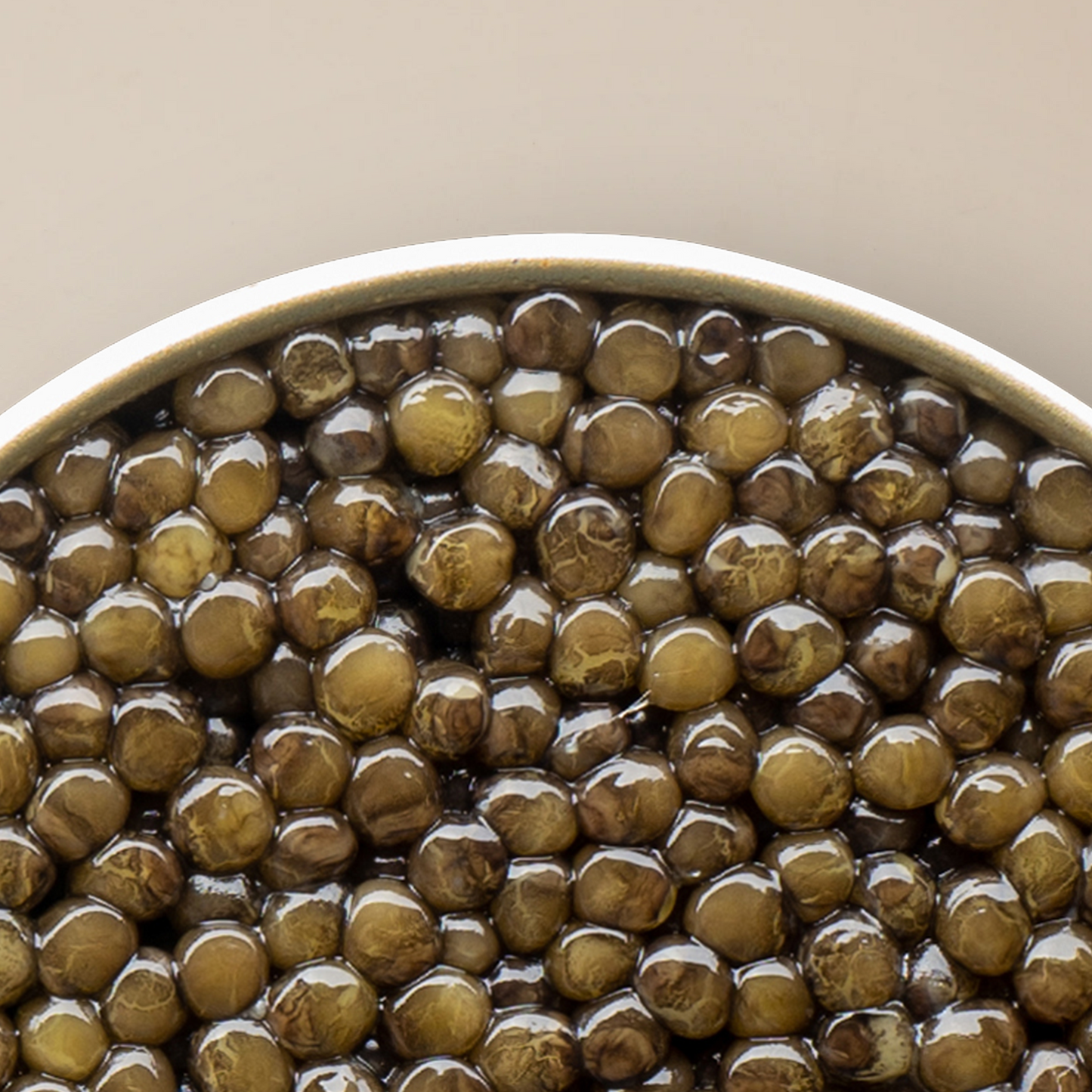 a close up of a bowl of caviar pearls with a white background